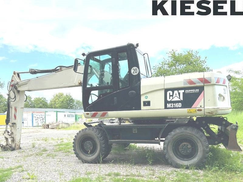 CAT M 316 D - Ekskavator me goma: foto 1 CAT M 316 D - Ekskavator me goma: foto 1