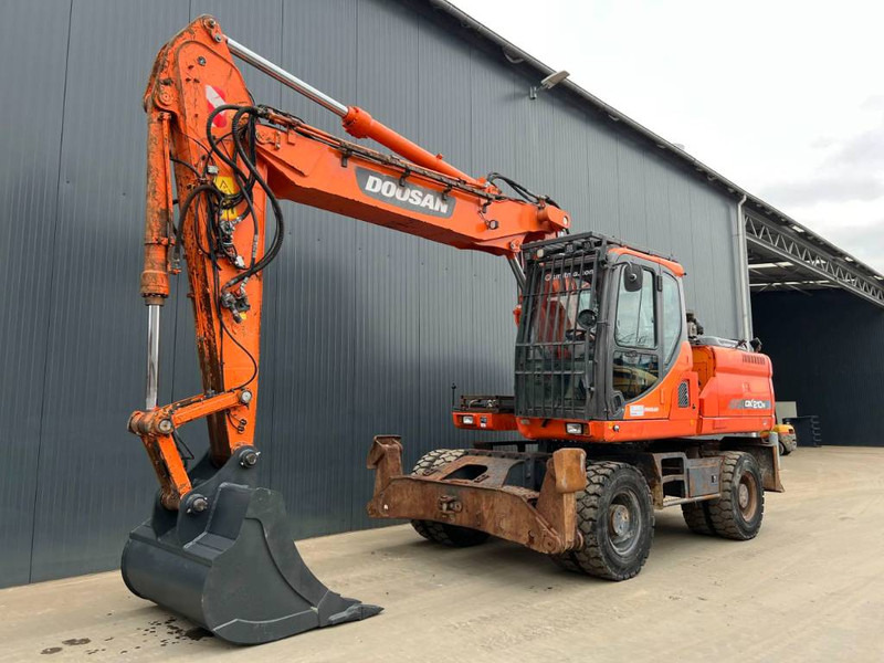 Doosan DX210W - Ekskavator me goma: foto 1 Doosan DX210W - Ekskavator me goma: foto 1