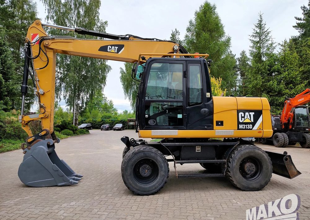 Caterpillar M313D - Ekskavator me goma: foto 1 Caterpillar M313D - Ekskavator me goma: foto 1