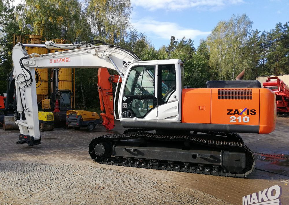 Hitachi ZX210 LC-5B - Ekskavator me zinxhirë: foto 2 Hitachi ZX210 LC-5B - Ekskavator me zinxhirë: foto 2