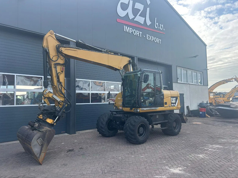 Caterpillar M313D - Ekskavator me goma: foto 1 Caterpillar M313D - Ekskavator me goma: foto 1