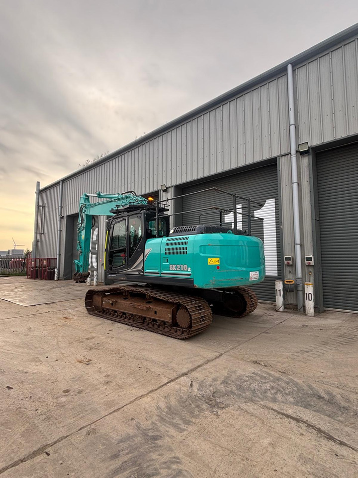 Kobelco SK210 LC-11 - Ekskavator me zinxhirë: foto 3 Kobelco SK210 LC-11 - Ekskavator me zinxhirë: foto 3