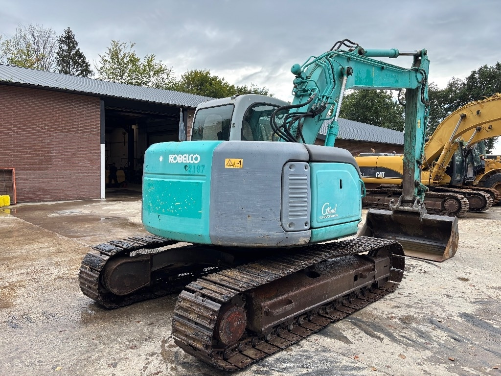 Kobelco SK 135 - Ekskavator me zinxhirë: foto 3 Kobelco SK 135 - Ekskavator me zinxhirë: foto 3