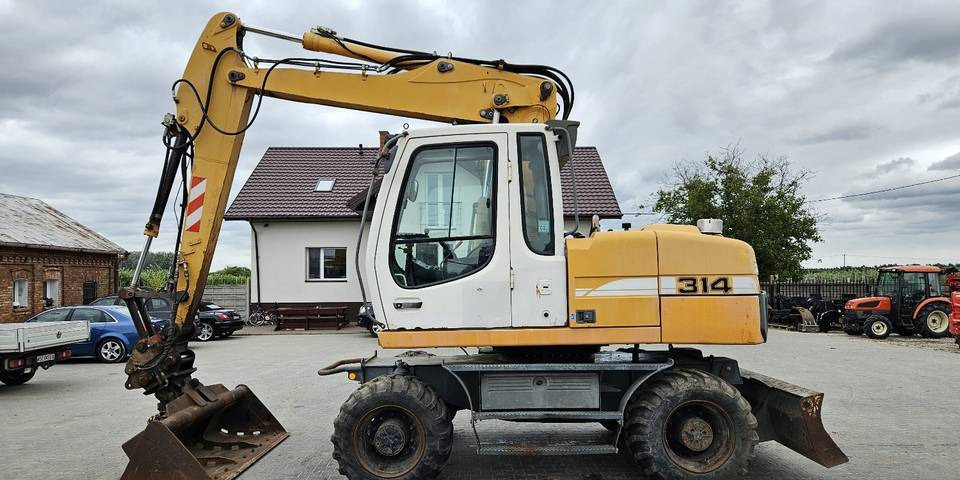 Koparka kołowa Liebherr A314 Litronic 9350 h+ 5 łyżek kołówka - Ekskavator me goma: foto 1 Koparka kołowa Liebherr A314 Litronic 9350 h+ 5 łyżek kołówka - Ekskavator me goma: foto 1