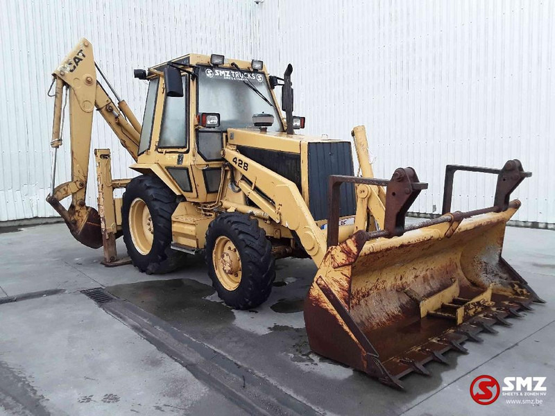 Caterpillar 428 - Fadromë me shkarkim nga prapa: foto 1 Caterpillar 428 - Fadromë me shkarkim nga prapa: foto 1