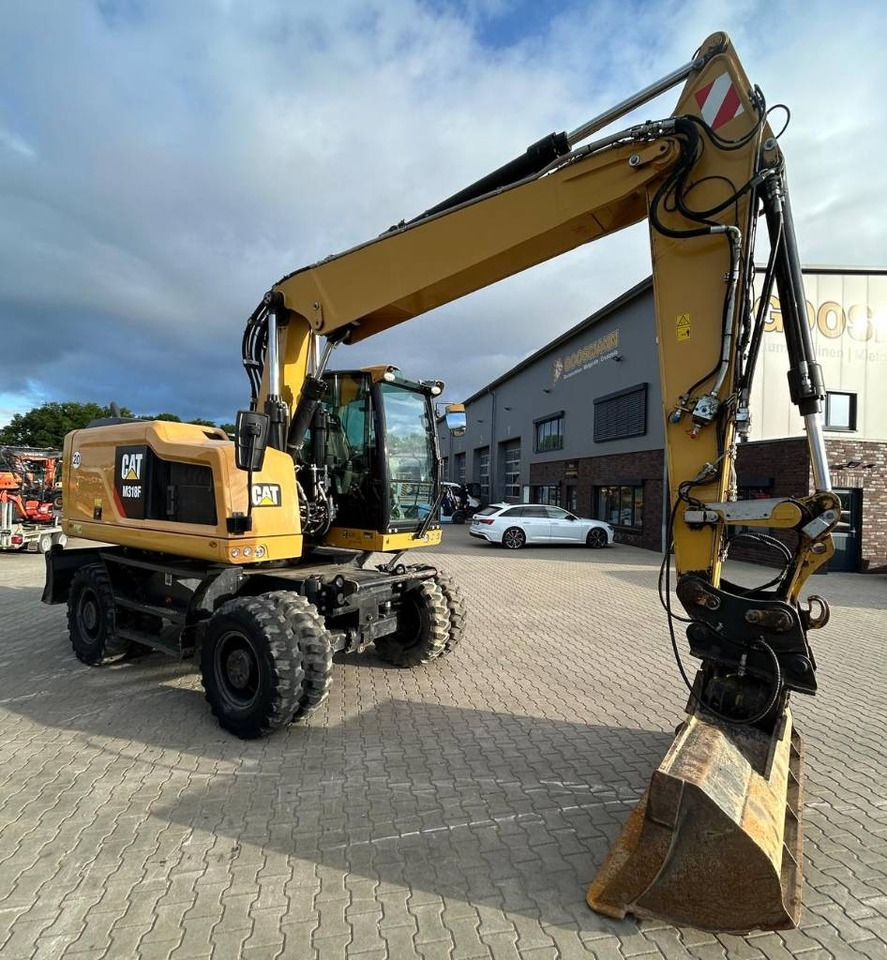 CAT M 318 F - Ekskavator me goma: foto 1 CAT M 318 F - Ekskavator me goma: foto 1